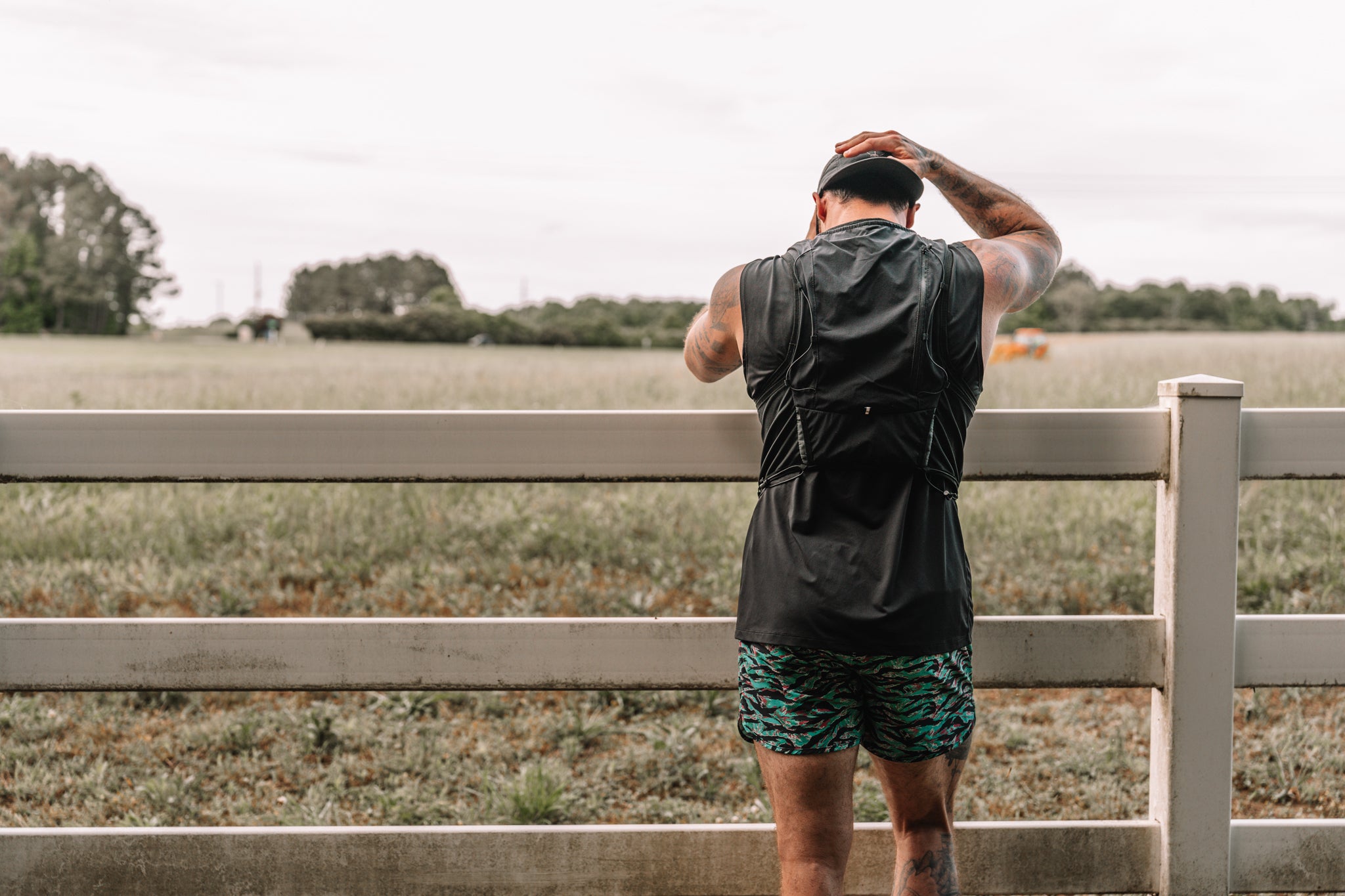 Miami Vibez Hybrid Short from behind at the fence