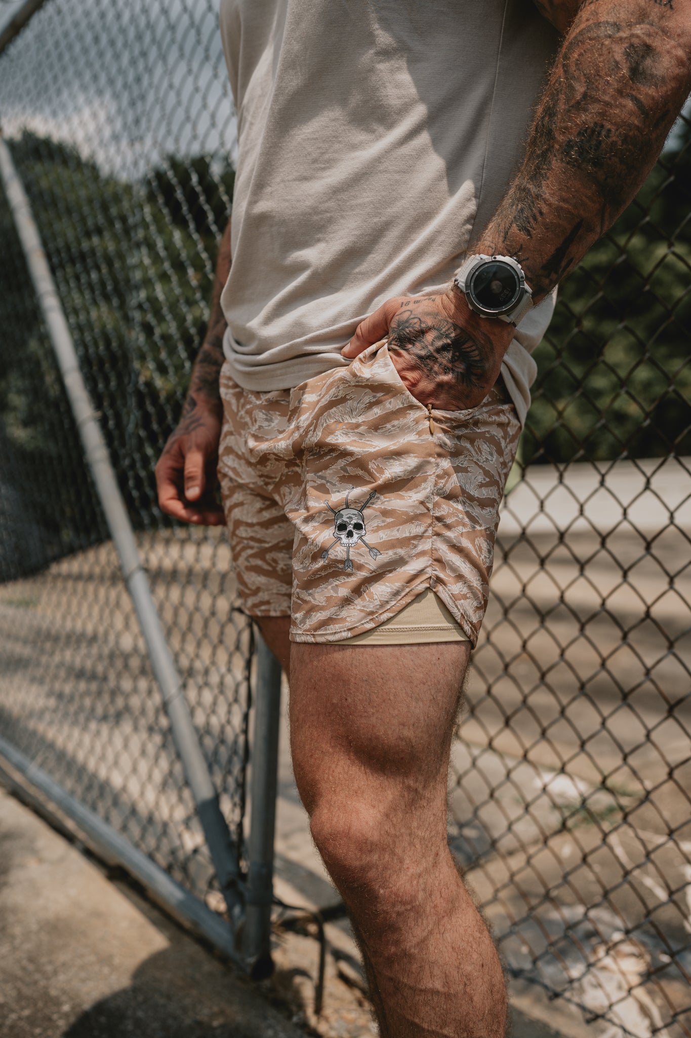 Hand in the zip side pocket of the Desert Tiger Hybrid Short