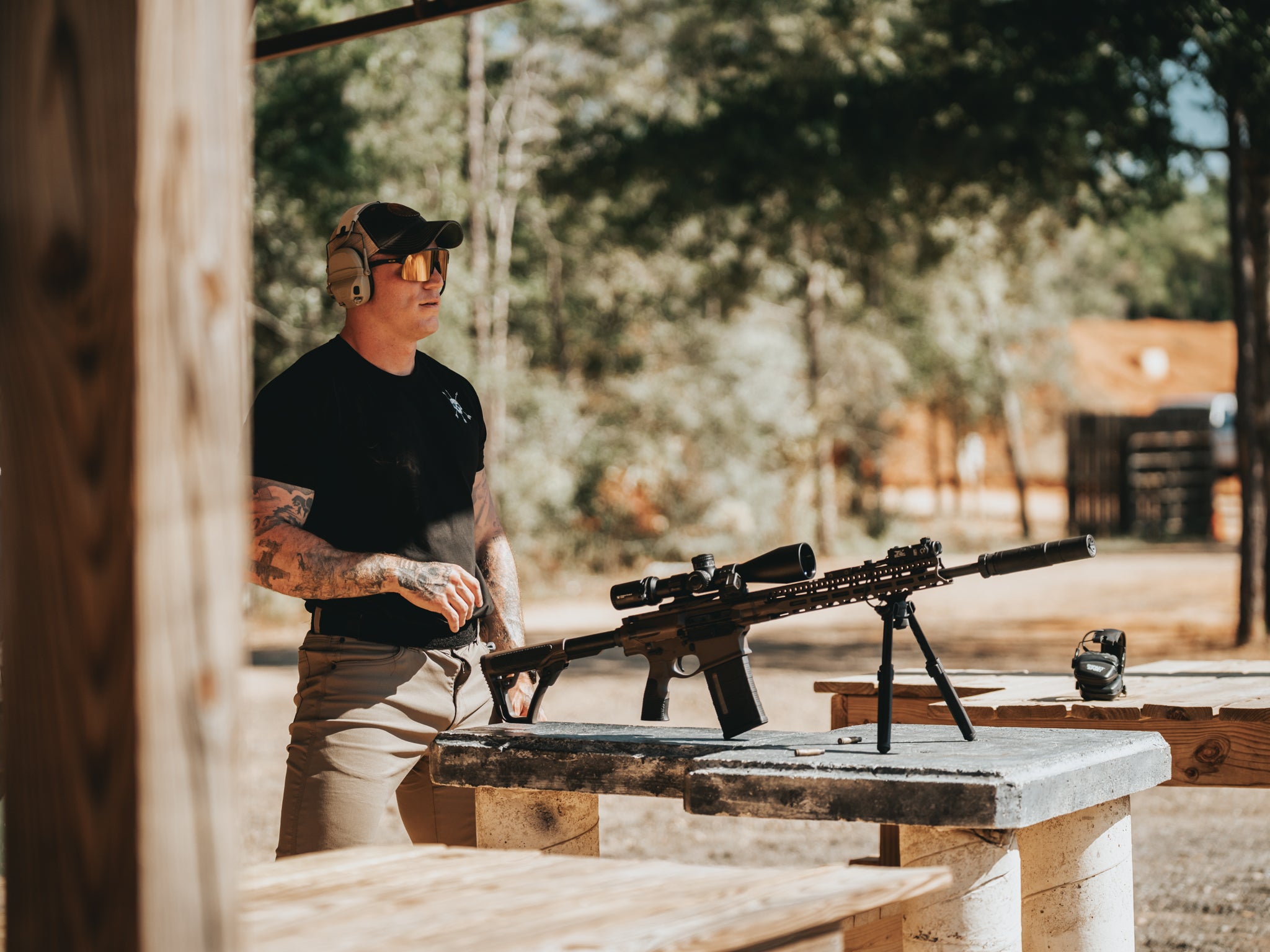 On the bench at the range in the Raider Tee